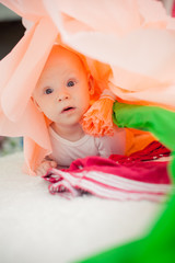 baby on the bed in a paper flower
