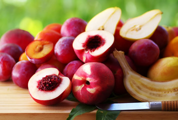 ripe nectarines and plums on table