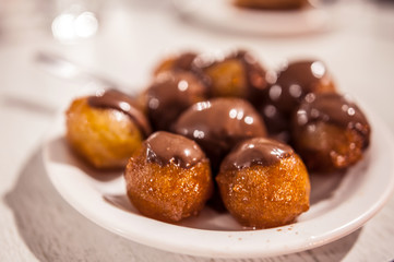 Vanilla doughnuts with chocolate sauce