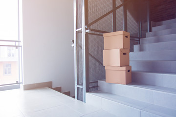 Moving boxes on stairs in house.