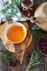 Healthy herbal tea with medicinal herbs, rose hip and honey. Rustic style