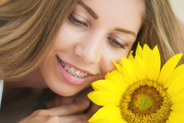 A woman is wearing braces 
