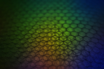 abstract background from plastic wrapper with colorful  dark light
