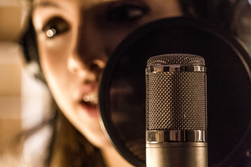 Girl recording vocals in a studio