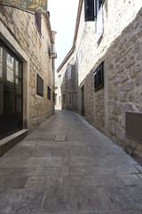 Fototapeta na wymiar Narrow empty street of medieval town
