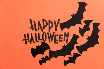 Black logo of Halloween and black bats painted on orange background