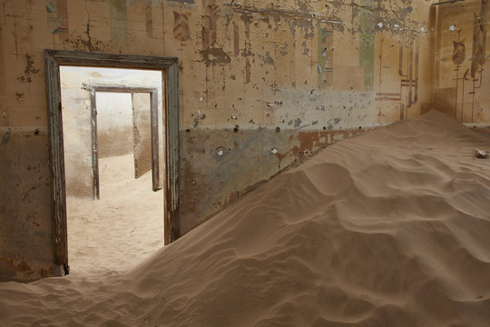Room in derelict building full of sand