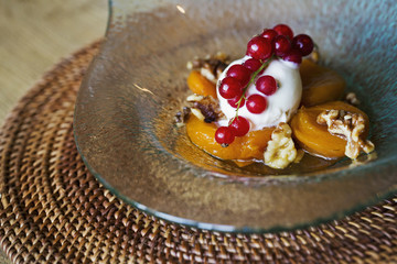 A fresh fruit desert with whipped cream and red currants