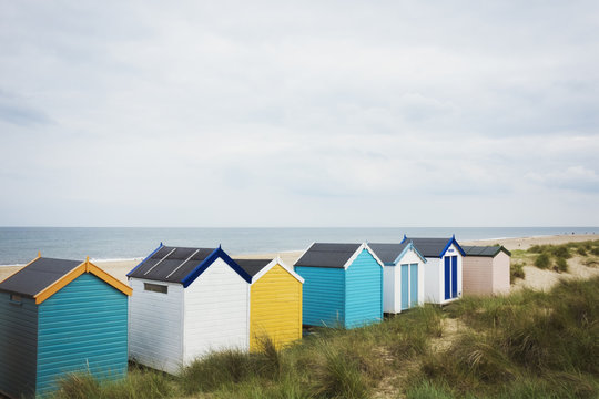 Beach huts in a row on a beach