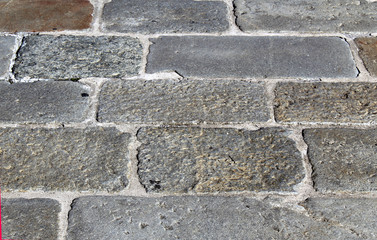 Rectangular rock tiles on a square outdoor pavement