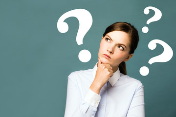 young woman with question marks.