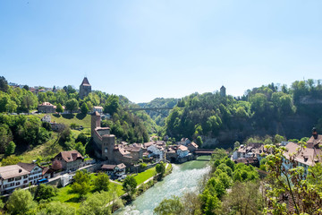 Fototapeta premium Cityscape of Fribourg town at Switzerland. There is Pont de Berne, ancient wooden bridge across river in image.