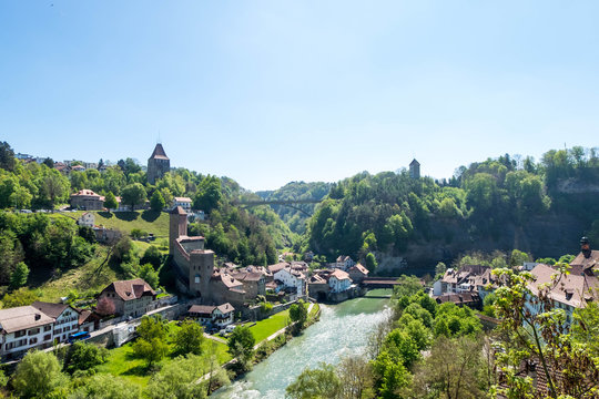 Cityscape of Fribourg town at Switzerland. There is Pont de Berne, ancient wooden bridge across river in image.