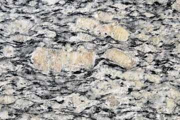Phorphyroclasts surrounded by foliation in ortogneiss metamorphic rock