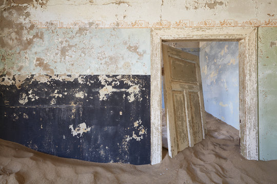 Room in derelict building full of sand
