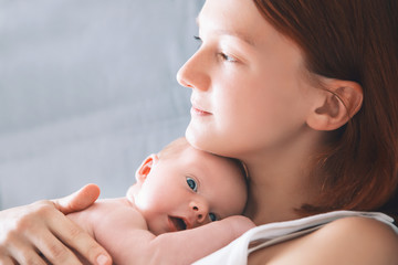 Newborn baby in hands of his mother.