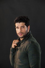 Man posing against black background