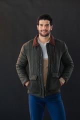Obraz premium Smiling man posing against black background