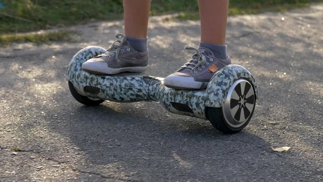 Legs of boy riding gyroboard. 4K, UHD