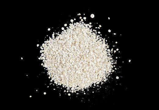 Dry oatmeal isolated on black background