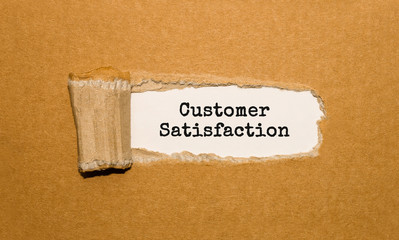 The text Customer Satisfaction appearing behind torn brown paper