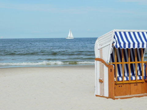 Hooded beach chair and  sailing-ship in Kolobrzeg