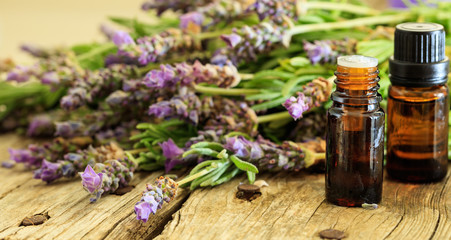 Fresh lavender and essential oil on wooden background