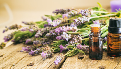 Obraz na płótnie Canvas Fresh lavender and essential oil on wooden background