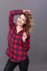 Young woman standing, isolated on gray background.