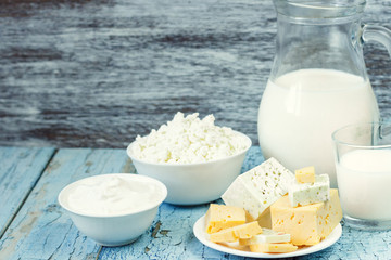 Different dairy products on the wooden background