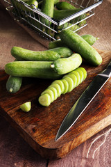 Fresh and sliced cucumbers. Sliced cucumbers on a cutting board.