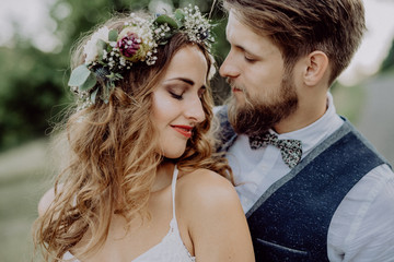 Beautiful bride and groom in green nature.
