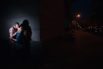 Secret romantic date at night. Kissing couple. Forbidden relationships, adultery, dark street...