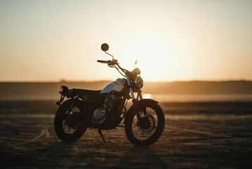 Door stickers Motorcycle  old custom beautiful cafe racer motorcycle in the desert at sunset or sunrise 