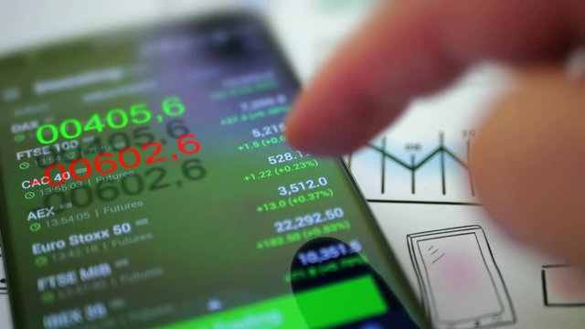 Businessman checking stock market data on smartphone. 4K UHD video.