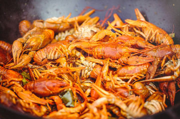 red large boiled crayfish in hot and apetized cauldron is steam