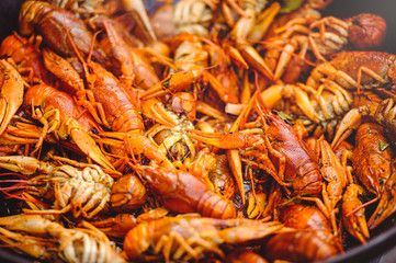 red large boiled crayfish in hot and apetized cauldron is steam