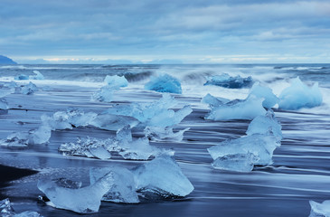 Jokulsarlon glacier lagoon, fantastic sunset on the black beach, Iceland.