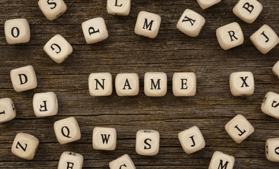 Word NAME written on wood block