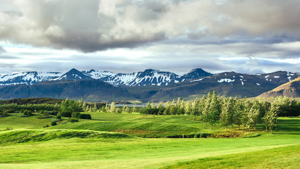 Obraz premium Valley National Park Landmannalaugar. On the gentle slopes of the mountains are snow fields and glaciers. Magnificent Iceland in the summer