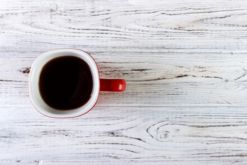 Red coffee cup on wooden table top view