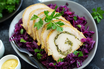 Fried pork loin stuffed with greens and red cabbage.