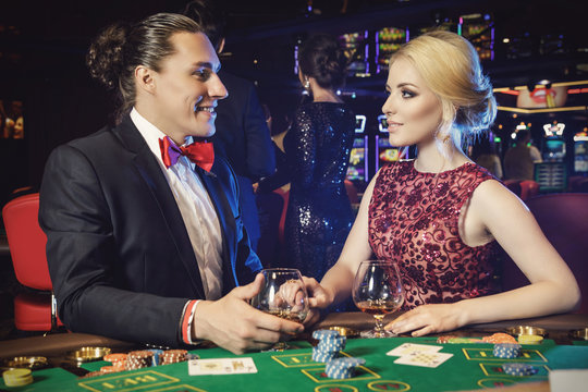 Young and beautiful couple in the casino
