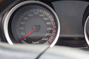 Close up shot of a speedometer in a car.