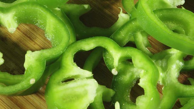 Rotating closeup view of sliced green peppers