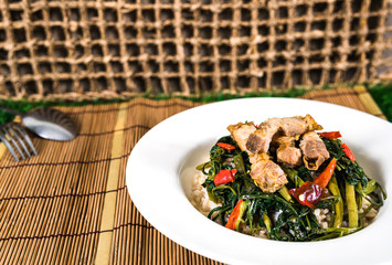 Stir-fried vegetable with morning glory in plate Along with eating equipment.