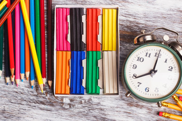 Different school supplies on the light wooden background