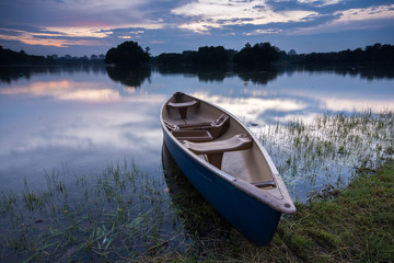 Naklejka na ściany i meble Blue kayak at the lake