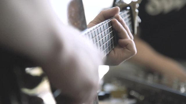 Man playing guitar slow motion