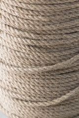 Close-up of fine sailing rope neatly wound up on a vertical spool